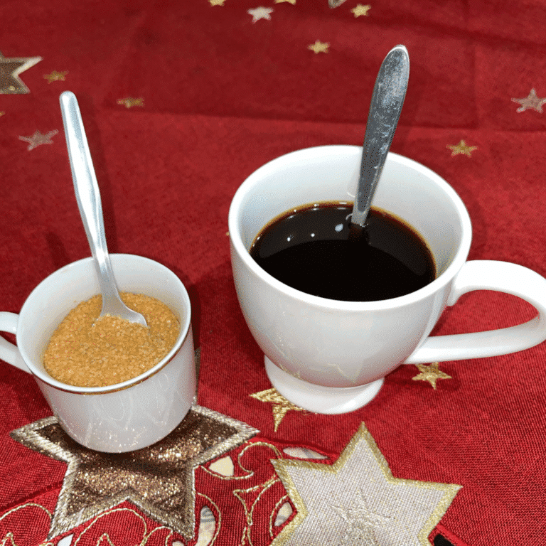 Ingredients for brown sugar in coffee on red holiday tablecloth