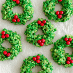no-bake cornflake wreaths holiday treats with red candy decorations on marble plate