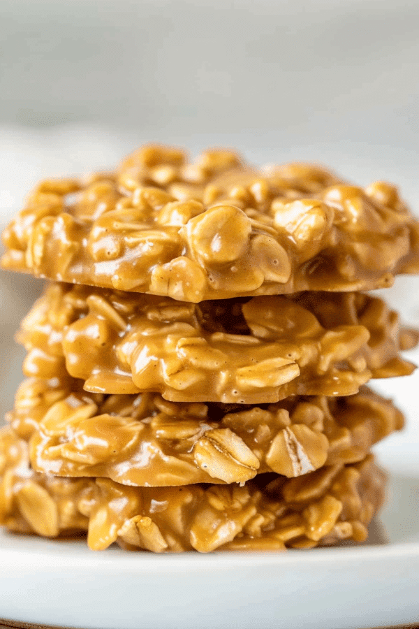 Stack of golden peanut butter no bake cookies made with corn syrup and oats