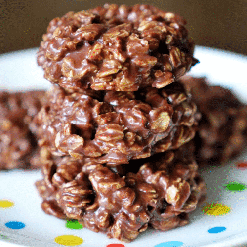 Stacked Classic No Bake Cookies with Honey showing chocolate, oats, and peanut butter texture up close on a white plate
