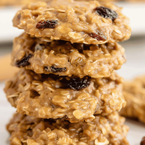 Tall stack of chewy classic no bake cookies with raisins, oats, and butter.