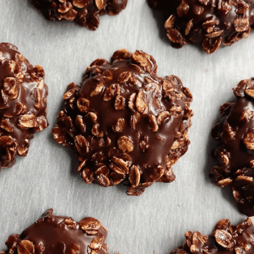 Top-down view of homemade no bake oatmeal fudge drop cookies with glossy chocolate and oats