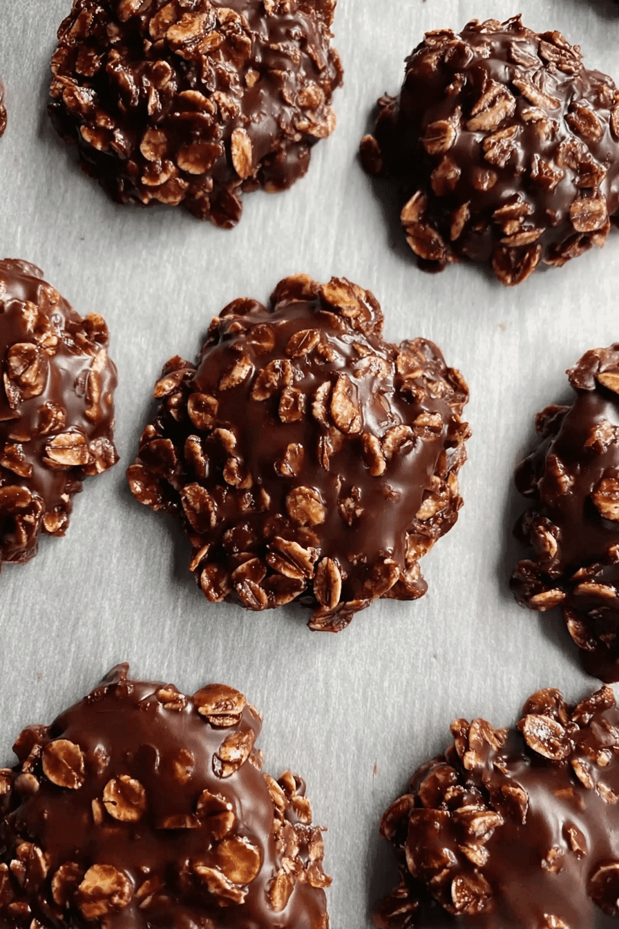 Top-down view of homemade no bake oatmeal fudge drop cookies with glossy chocolate and oats
