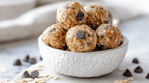 Clean-eating energy balls made with oats and chocolate chips in a white ceramic bowl
