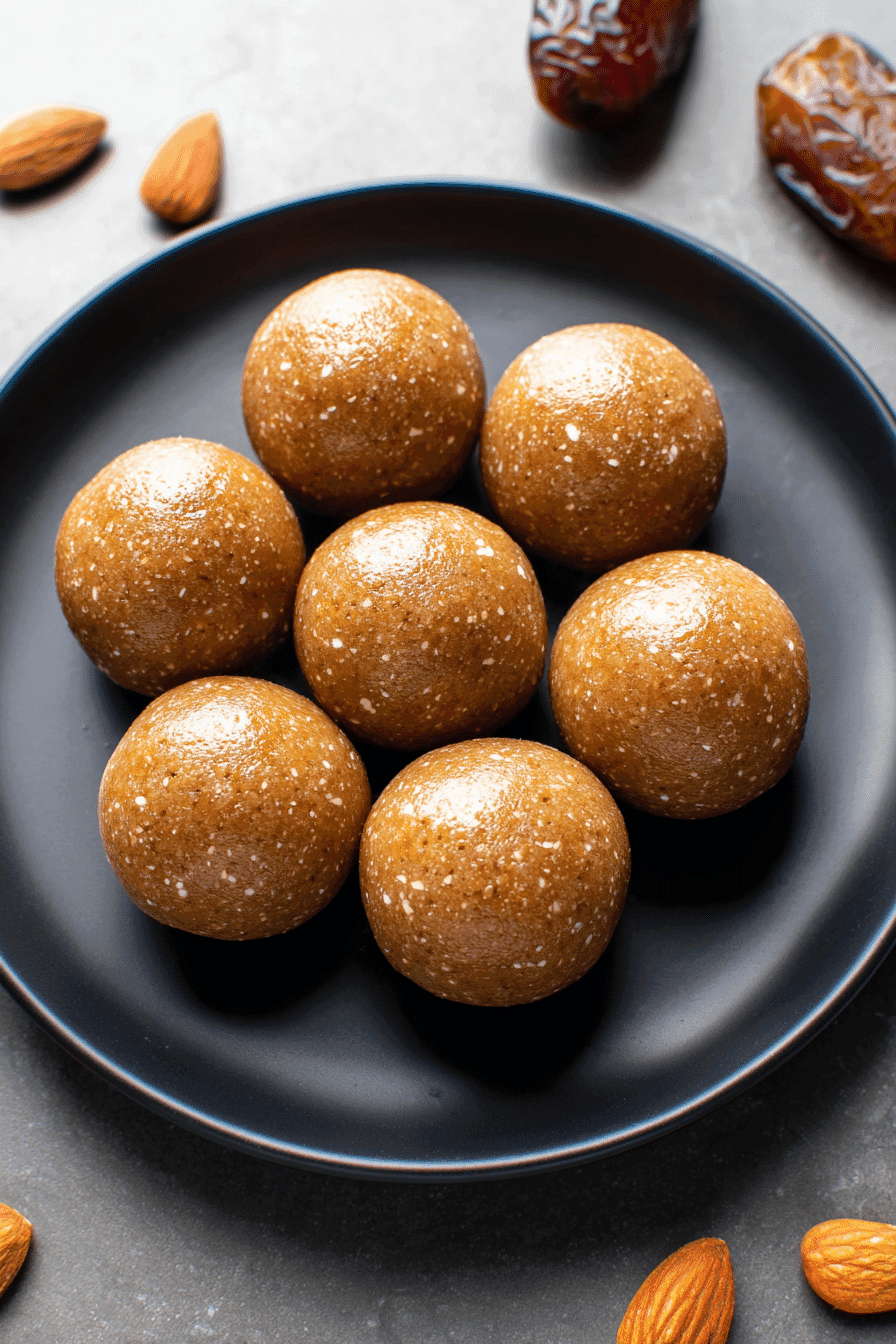 No-sugar-added date and almond energy balls on black plate