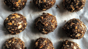 Glow in the Dark No Bake Cookies made with oats, dark chocolate, chia seeds, and almonds on parchment paper