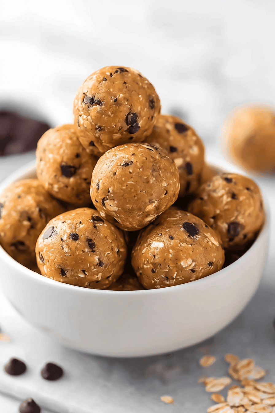 High-protein energy balls with oats and chocolate chips in a white bowl
