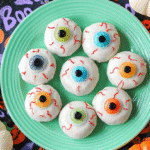no bake cookies with candy eyes on a green plate surrounded by pumpkins
