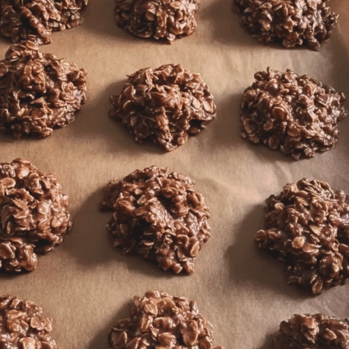 Nut-free chocolate oat no bake cookies arranged on parchment paper, perfect for school snacks.