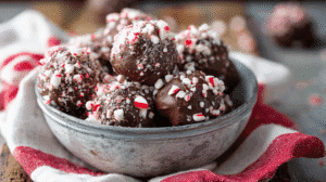 Peppermint mocha no bake bites coated in crushed candy canes, holiday dessert in rustic bowl