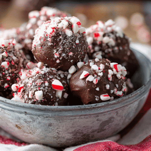 Peppermint mocha no bake bites coated in crushed candy canes, holiday dessert in rustic bowl
