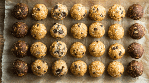 Post-workout protein balls made with oats, peanut butter, and chocolate chips arranged on parchment paper