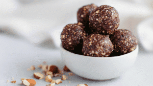 Raw vegan energy balls with nuts in a white bowl
