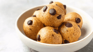 vegan no-bake cookie bites with chocolate chips in a ceramic bowl.