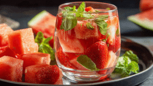 Watermelon fruit-infused water with fresh strawberries and mint leaves