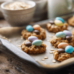 quick and easy no bake Easter cookies with pastel candy eggs on parchment tray in bright spring kitchen